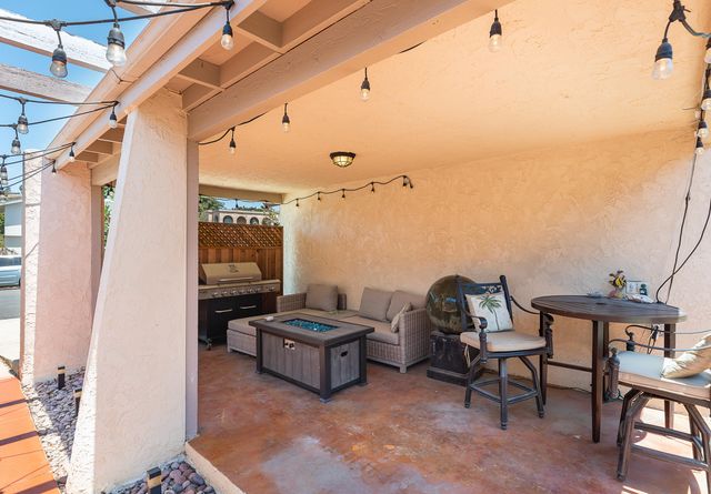 a view of a patio with table and chairs and couches