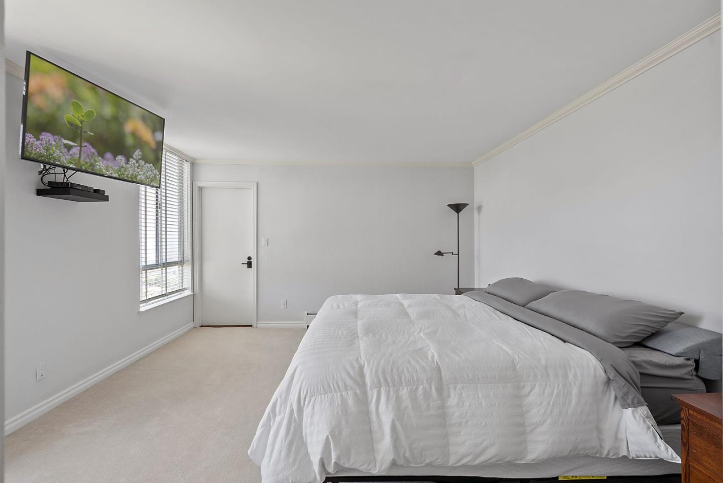 320 Vallejo Drive, Unit 41 Millbrae, CA 94030 - Photo 19 of 37 a bedroom with a bed and a flat screen tv