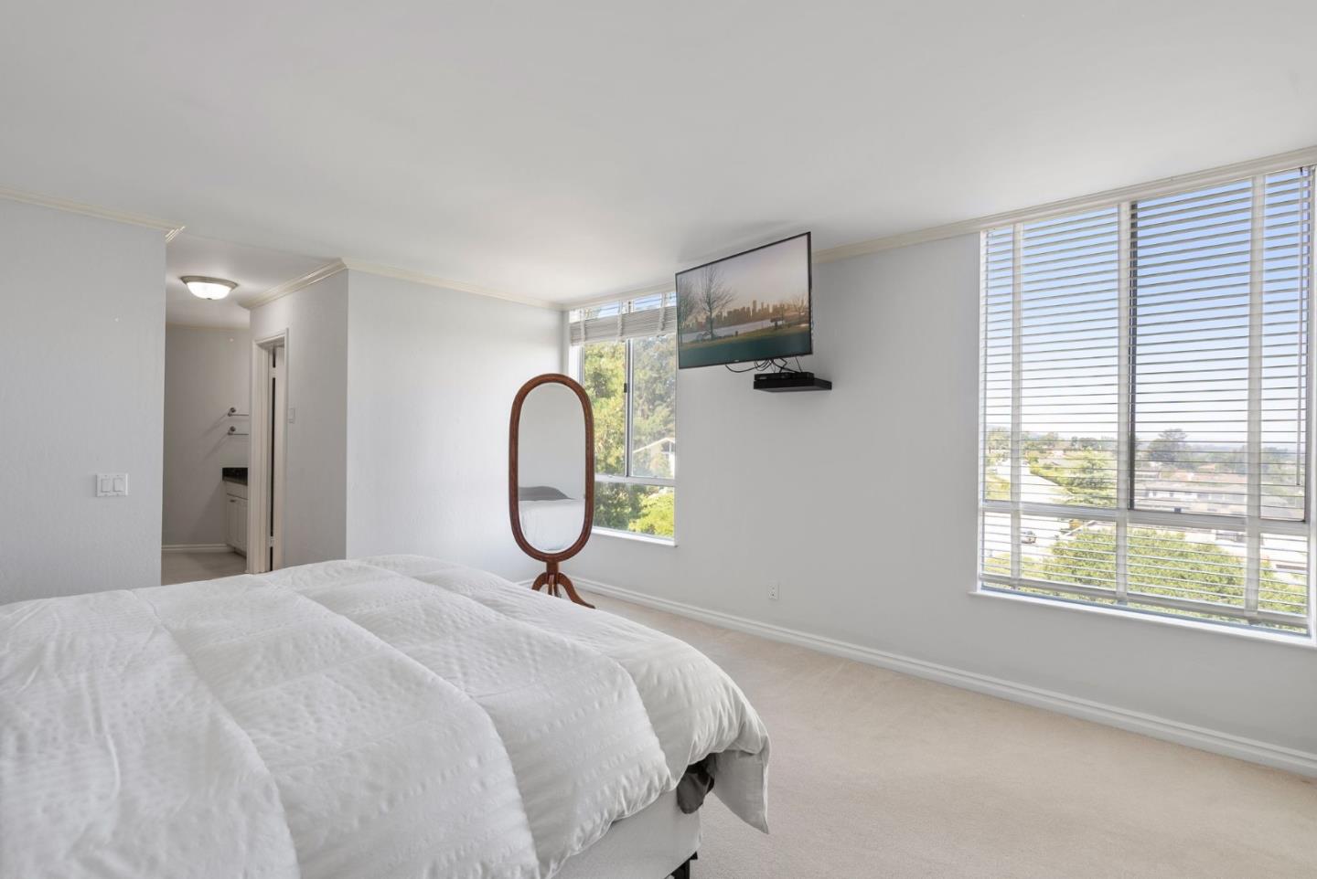 320 Vallejo Drive, Unit 41 Millbrae, CA 94030 - Photo 20 of 37 a bedroom with a bed a window and a flat screen tv