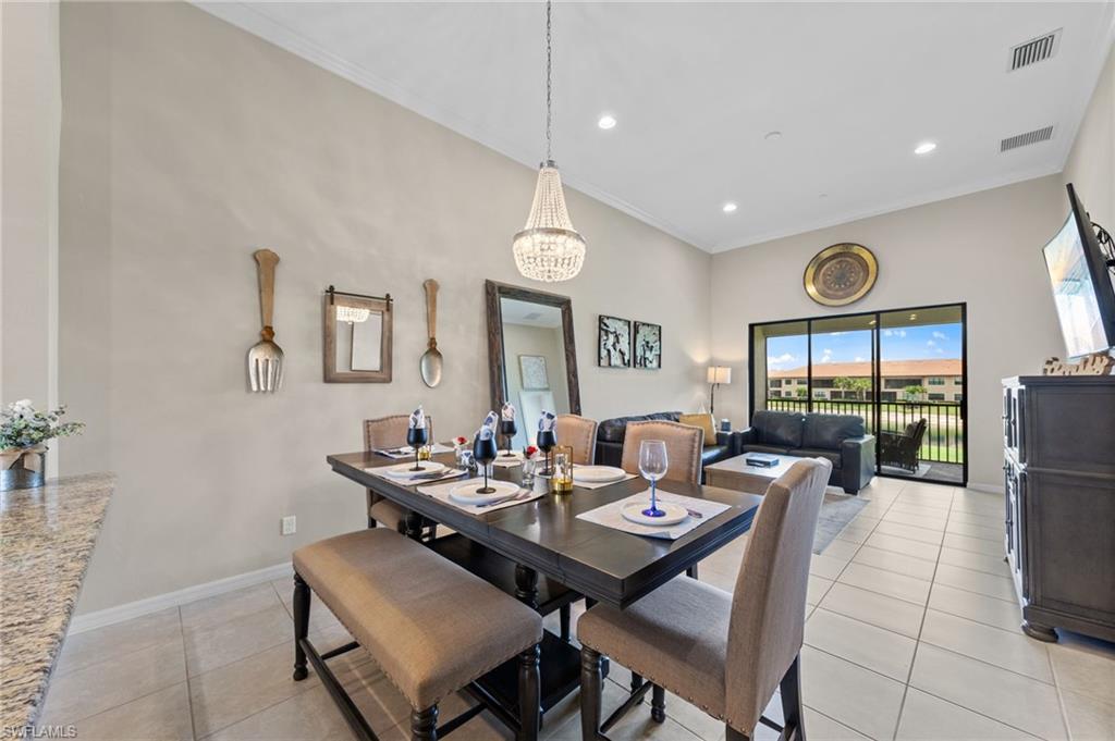 9366 Pocida Court, Unit 202 Naples, FL 34119 - Photo 6 of 44 a view of a dining room with furniture window and wooden floor