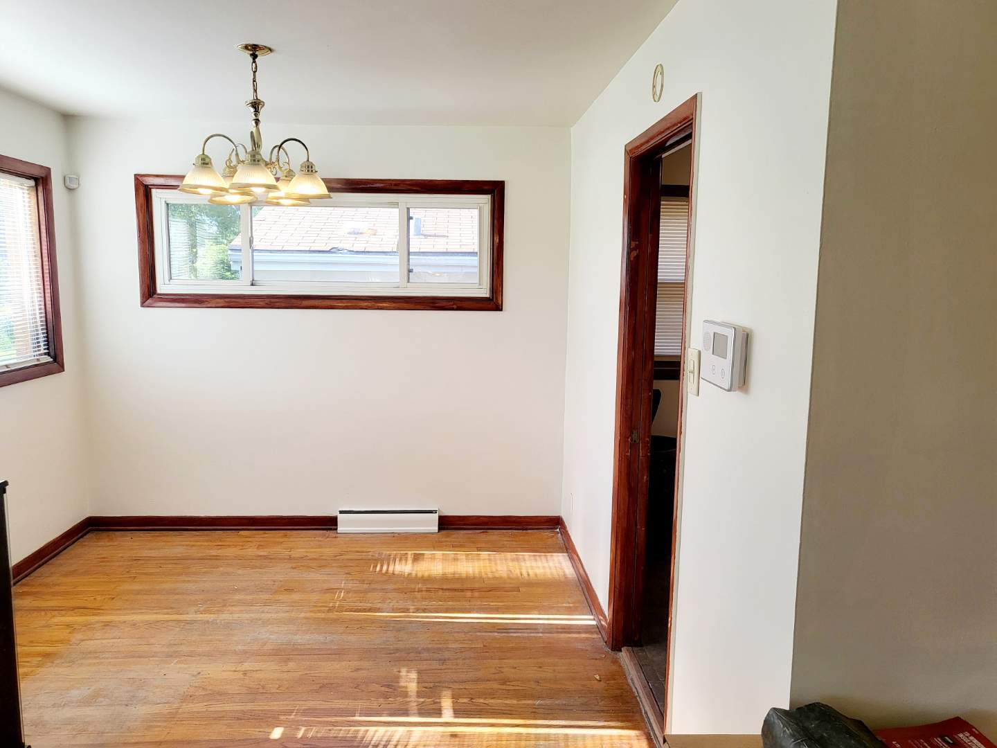 15041 Cottage Grove Avenue Dolton, IL 60419 - Photo 3 of 11 a view of an empty room with wooden floor and windows