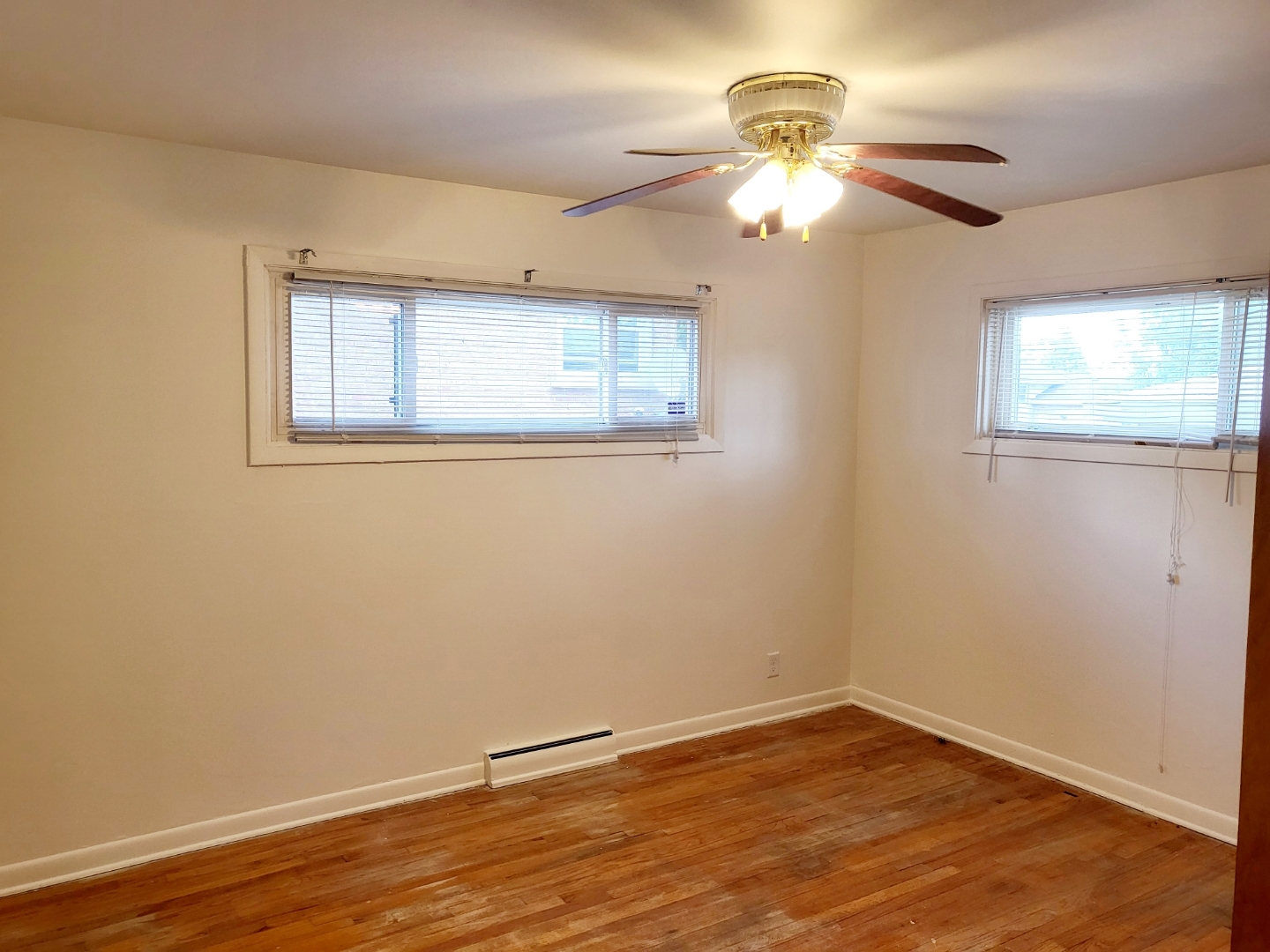 15041 Cottage Grove Avenue Dolton, IL 60419 - Photo 6 of 11 a view of an empty room with wooden floor and a window