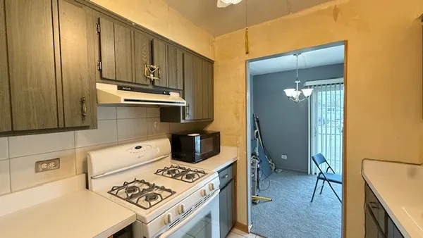 a kitchen with a stove and a refrigerator