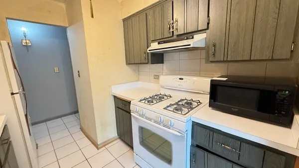 a kitchen with cabinets and appliances
