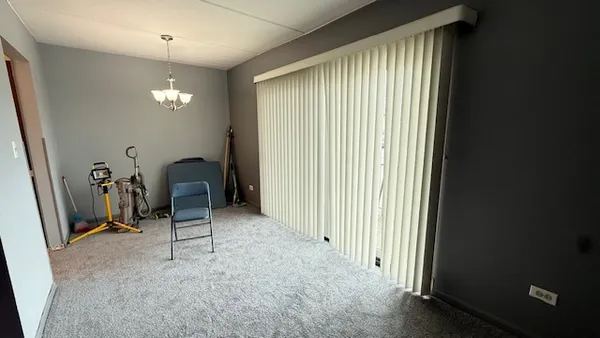 a view of a room with gym equipment and a large window