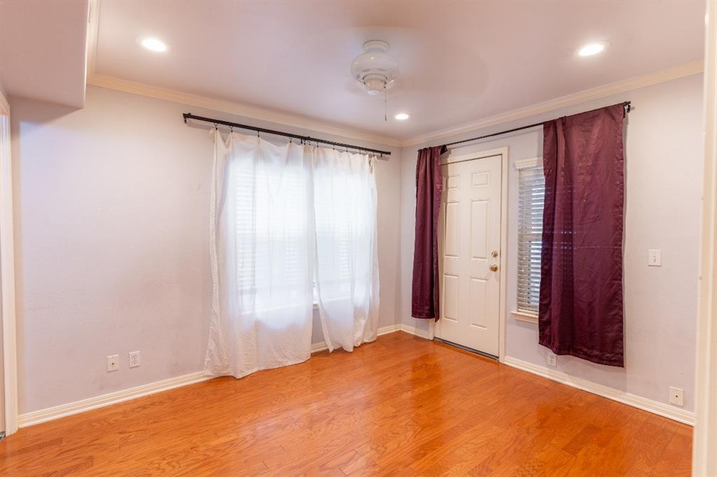 3009 Speedway, Unit 2 Austin, TX 78705 - Photo 7 of 10 Natural light illuminates rich hardwood floors, creating a warm and welcoming ambiance in this inviting room.