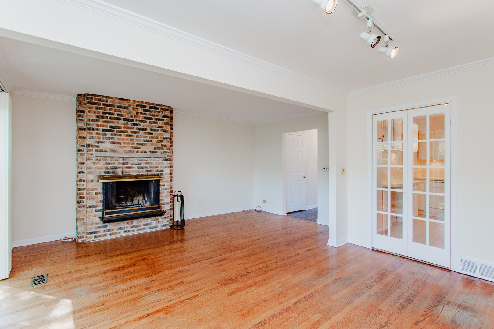 590 Green Bay Road Glencoe, IL 60022 - Photo 7 of 33 a view of an empty room with wooden floor fireplace and a window