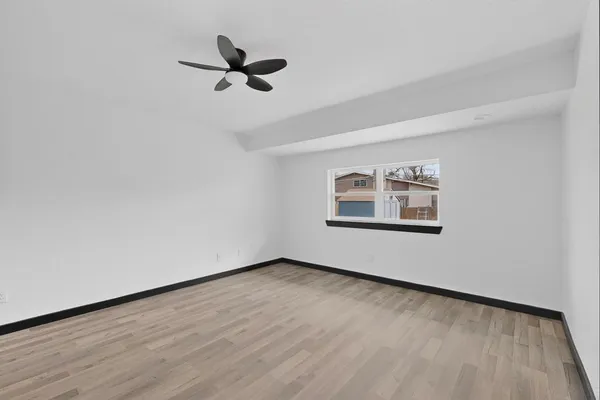 a view of a ceiling fan and wooden floor