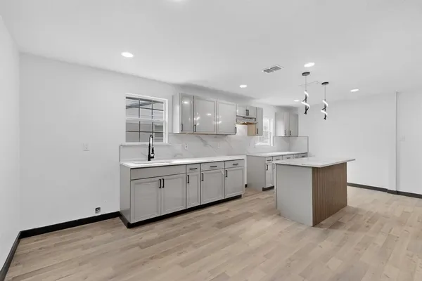 a large kitchen with a white wooden cabinets and white appliances
