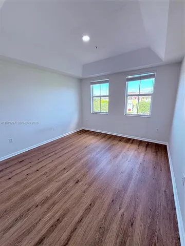 a view of room with wooden floor and window