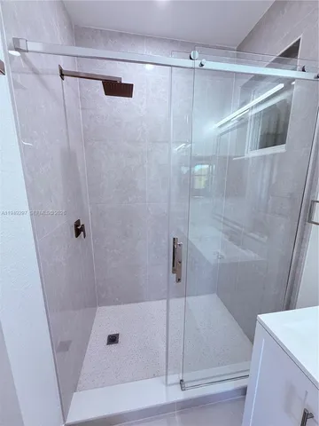a bathroom with a shower and a tub
