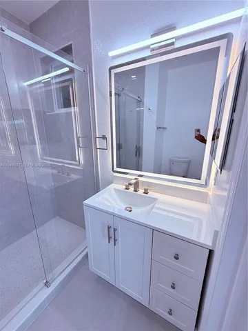 a bathroom with a double vanity sink and mirror