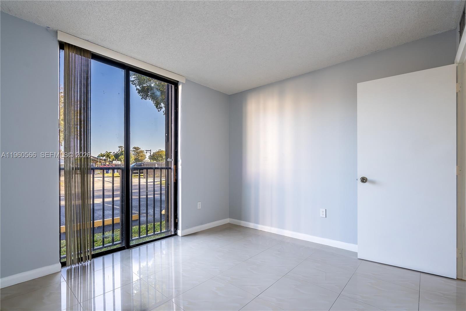 6795 Southwest 132nd Avenue, Unit 101 Miami, FL 33183 - Photo 12 of 37 a view of a room that has a large window