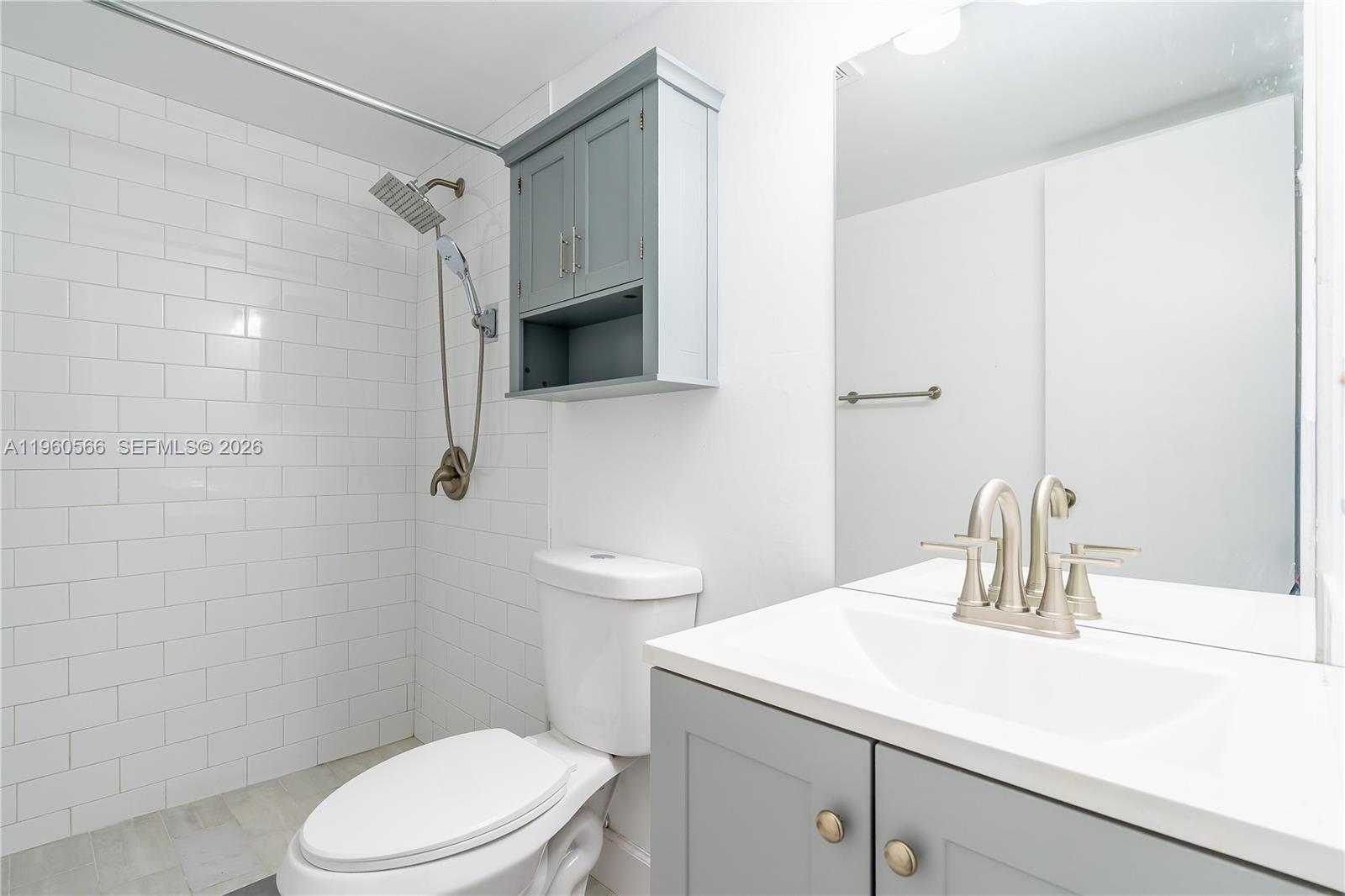 6795 Southwest 132nd Avenue, Unit 101 Miami, FL 33183 - Photo 14 of 37 a bathroom with a sink a toilet and shower