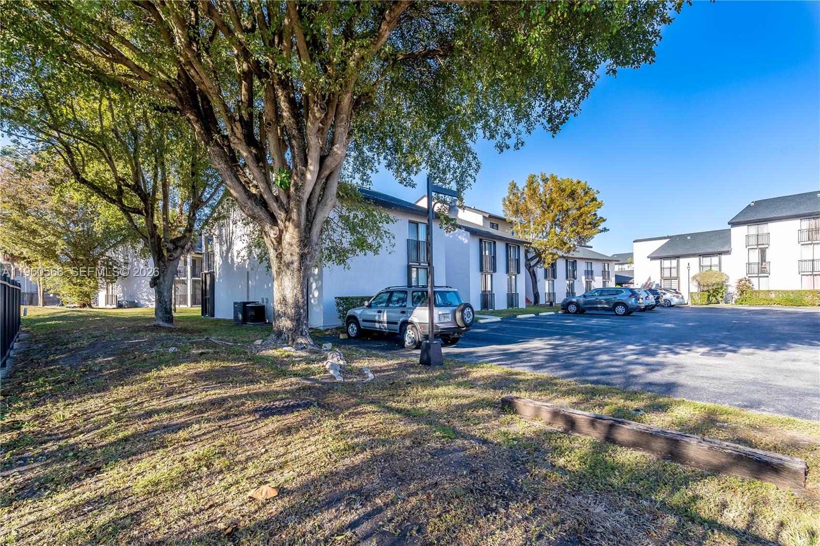6795 Southwest 132nd Avenue, Unit 101 Miami, FL 33183 - Photo 18 of 37 a view of a house with a large tree and sitting area