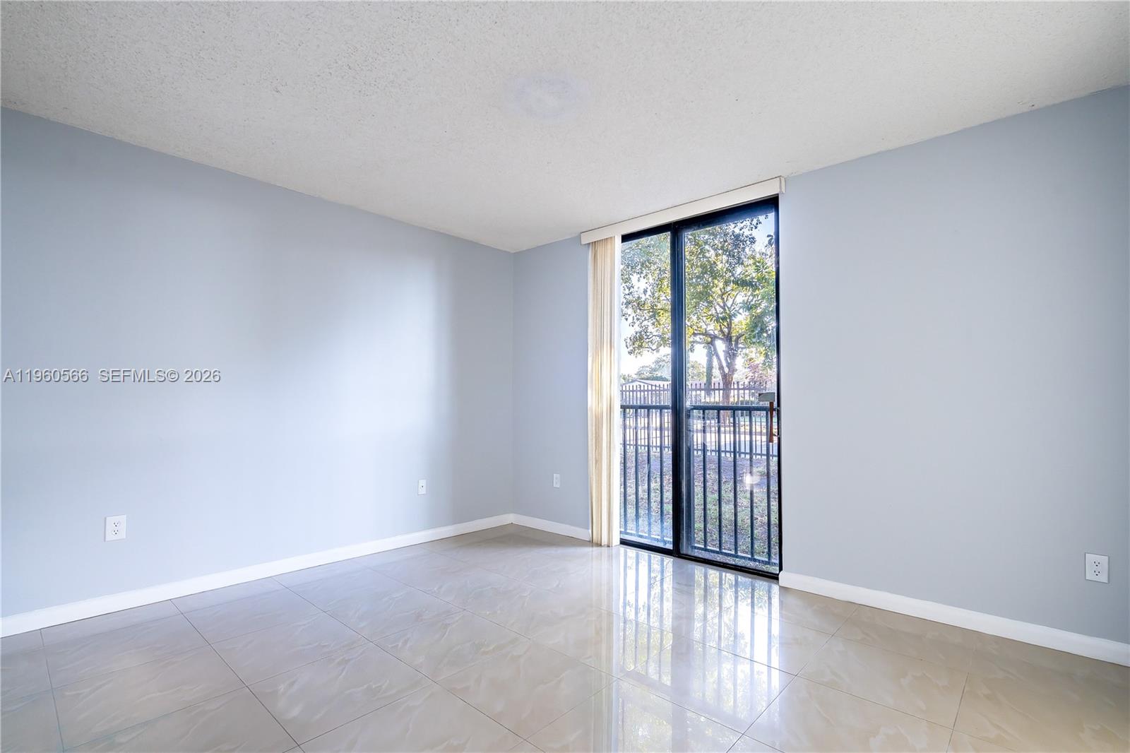 6795 Southwest 132nd Avenue, Unit 101 Miami, FL 33183 - Photo 19 of 37 an empty room with wooden floor and windows