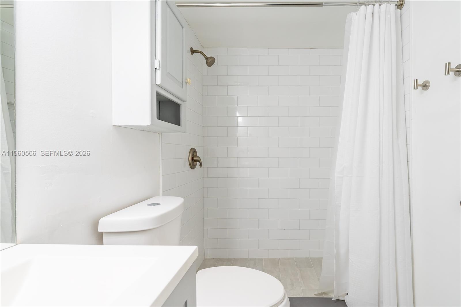 6795 Southwest 132nd Avenue, Unit 101 Miami, FL 33183 - Photo 23 of 37 a white toilet sitting next to a bathroom sink