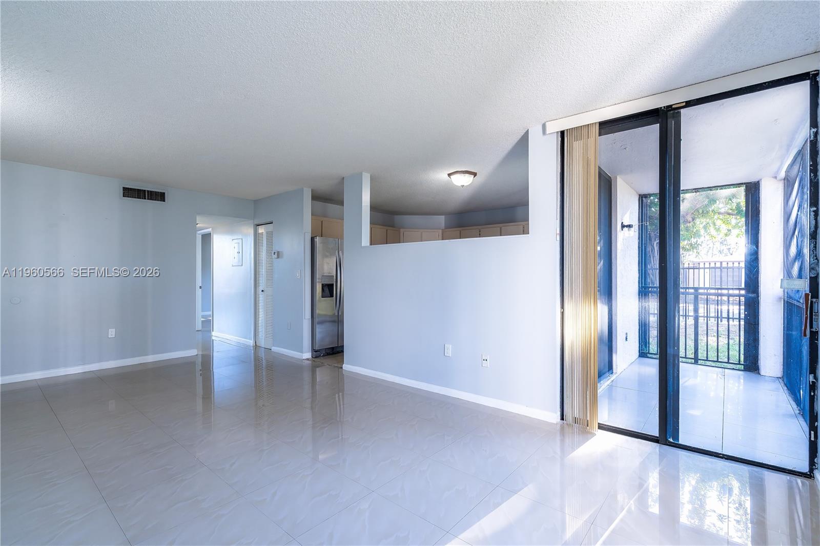 6795 Southwest 132nd Avenue, Unit 101 Miami, FL 33183 - Photo 29 of 37 a view of an empty room and window