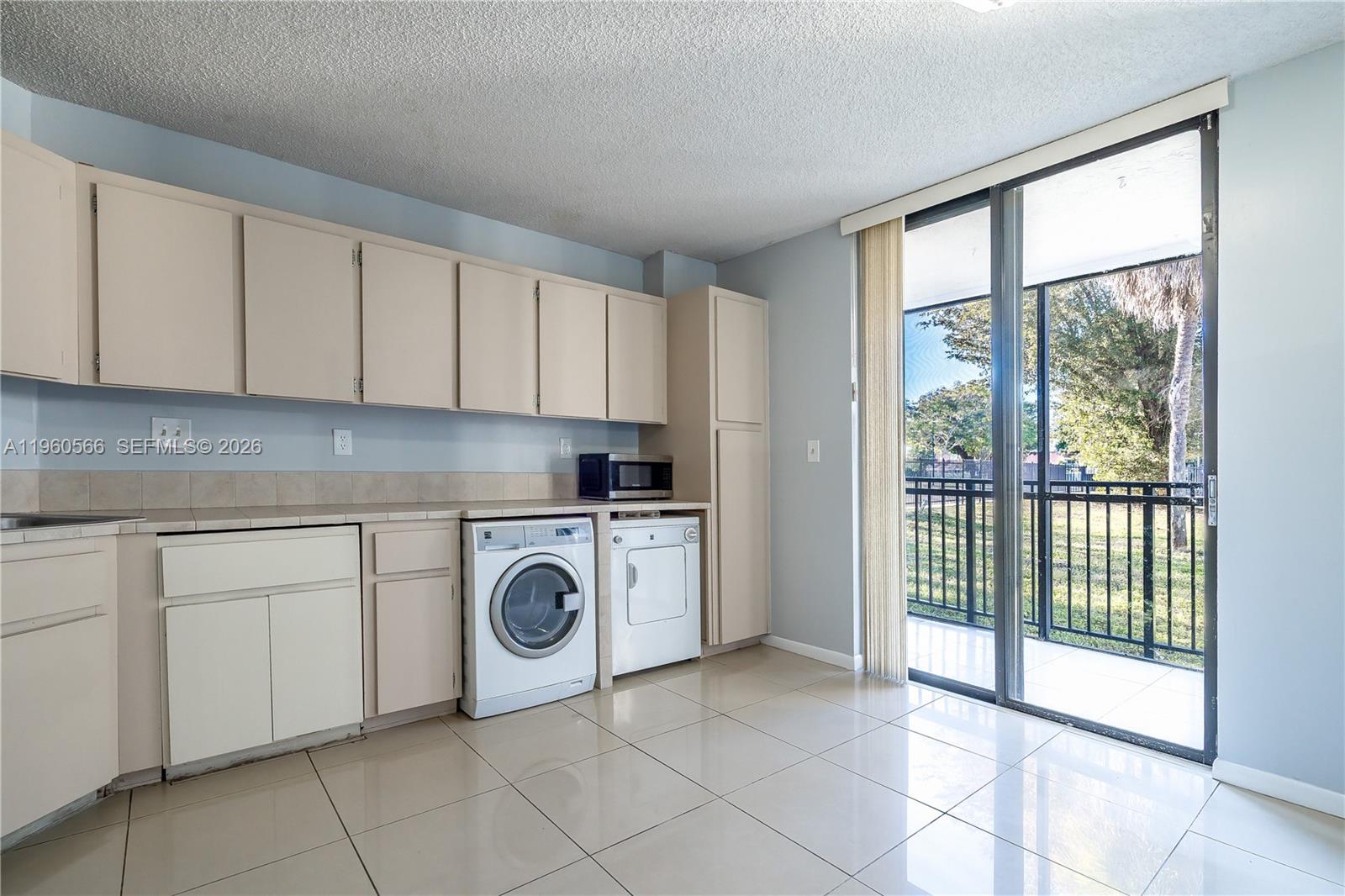 6795 Southwest 132nd Avenue, Unit 101 Miami, FL 33183 - Photo 31 of 37 a view of a kitchen with washing machine and washing machine