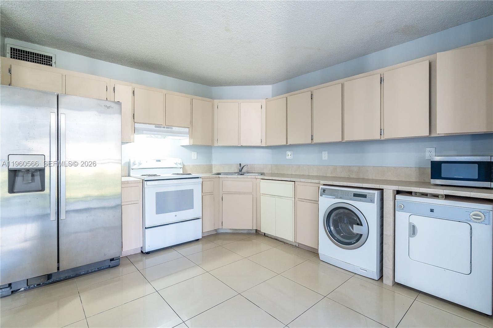 6795 Southwest 132nd Avenue, Unit 101 Miami, FL 33183 - Photo 33 of 37 a kitchen with cabinets and steel stainless steel appliances