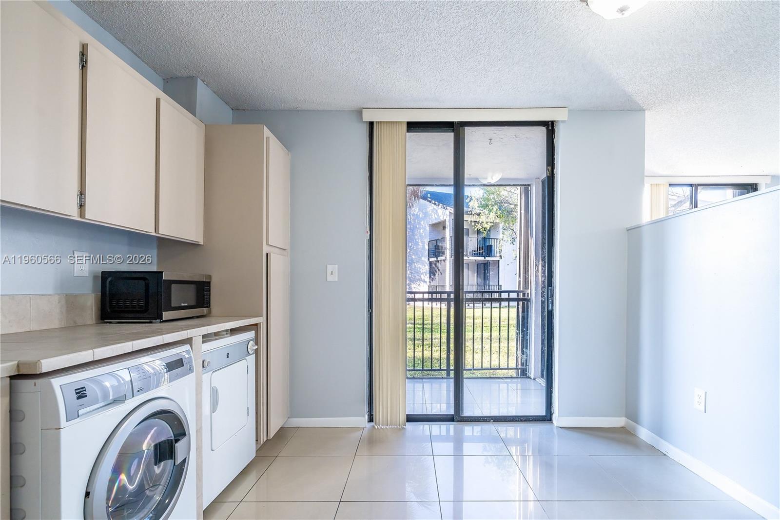 6795 Southwest 132nd Avenue, Unit 101 Miami, FL 33183 - Photo 36 of 37 a view of livingroom with washer and dryer