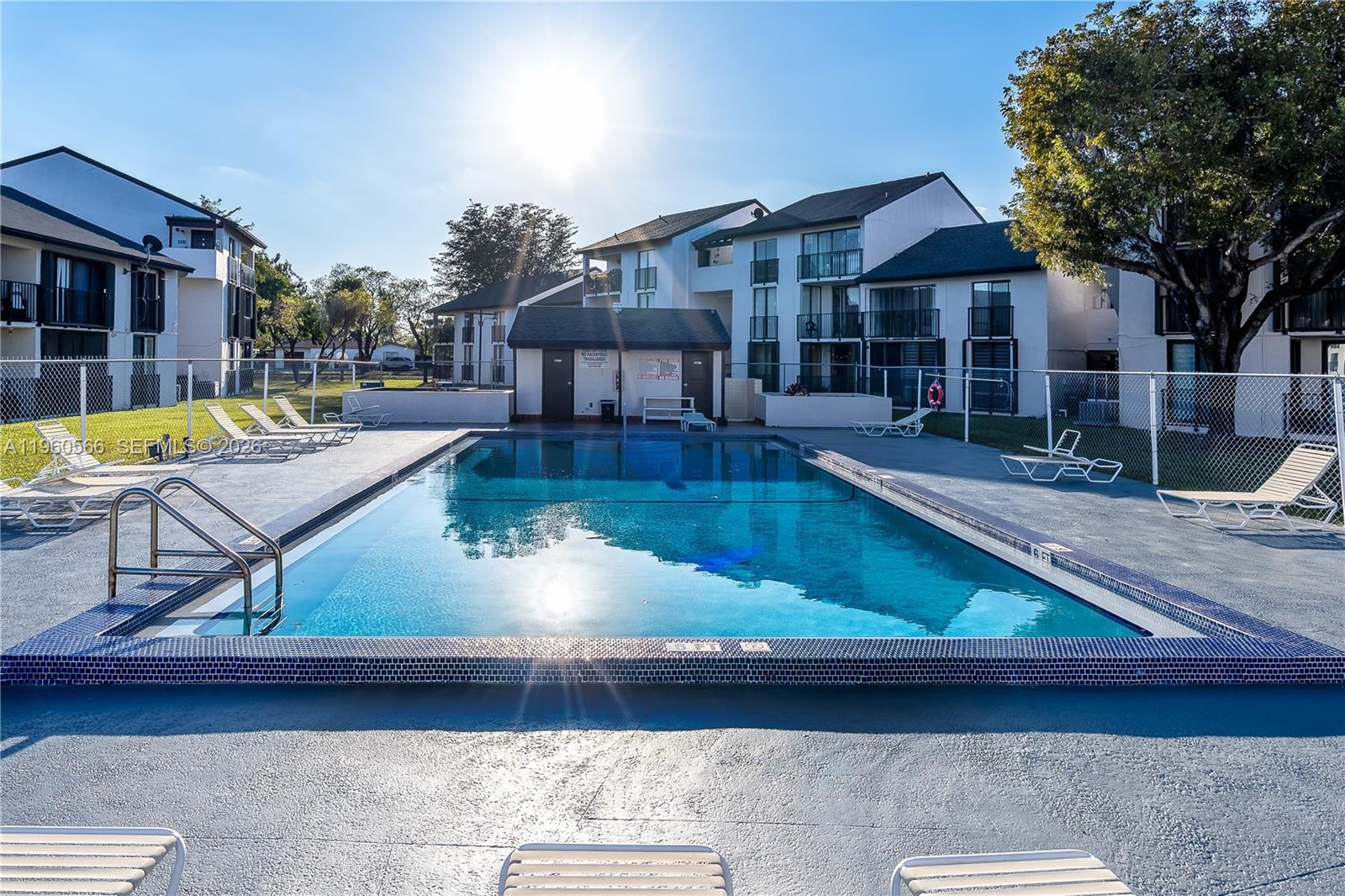 6795 Southwest 132nd Avenue, Unit 101 Miami, FL 33183 - Photo 8 of 37 a view of a house with swimming pool and sitting area