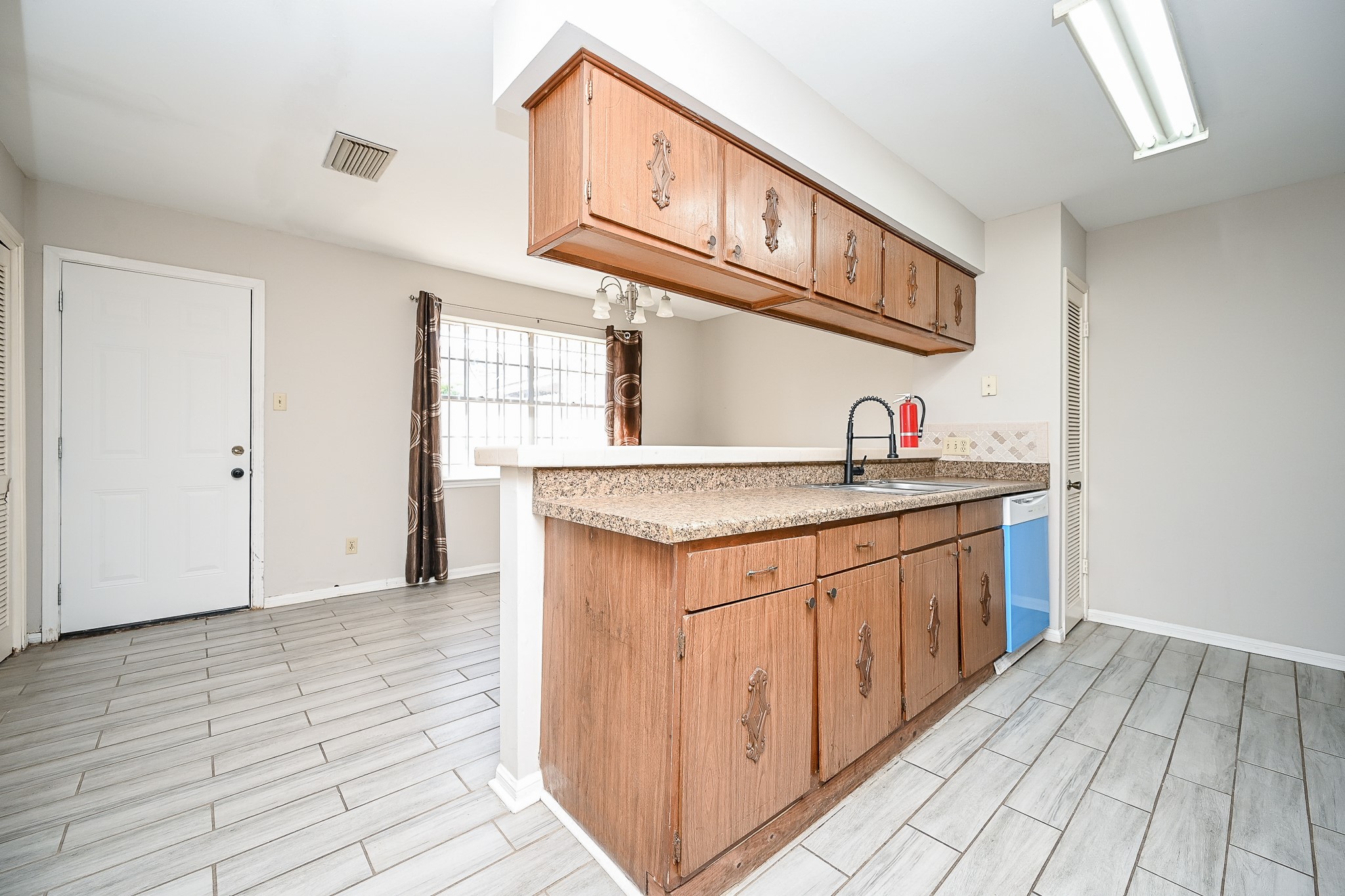 7878 Leonora Street Houston, TX 77061 - Photo 12 of 33 a kitchen with stainless steel appliances granite countertop a sink and dishwasher with wooden cabinets