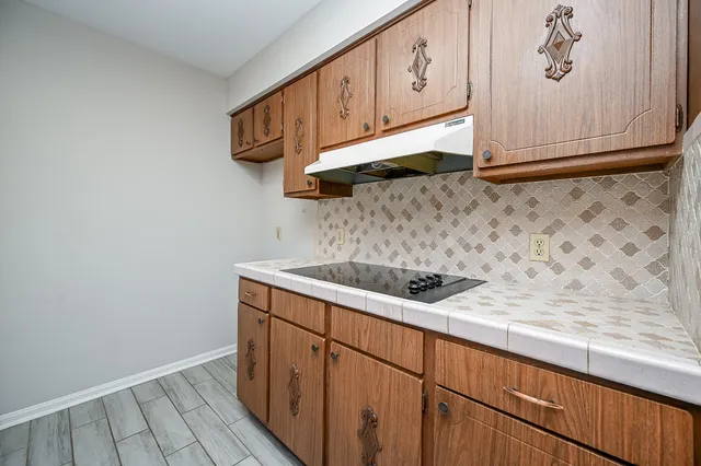 a kitchen with stainless steel appliances granite countertop white cabinets and a sink