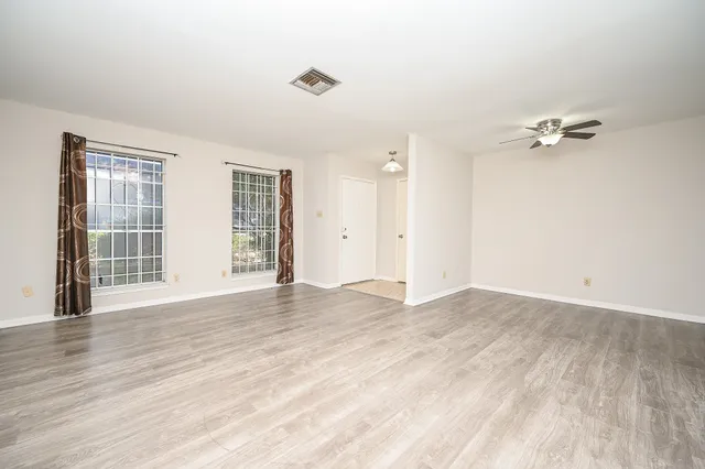 wooden floor in an empty room with a window