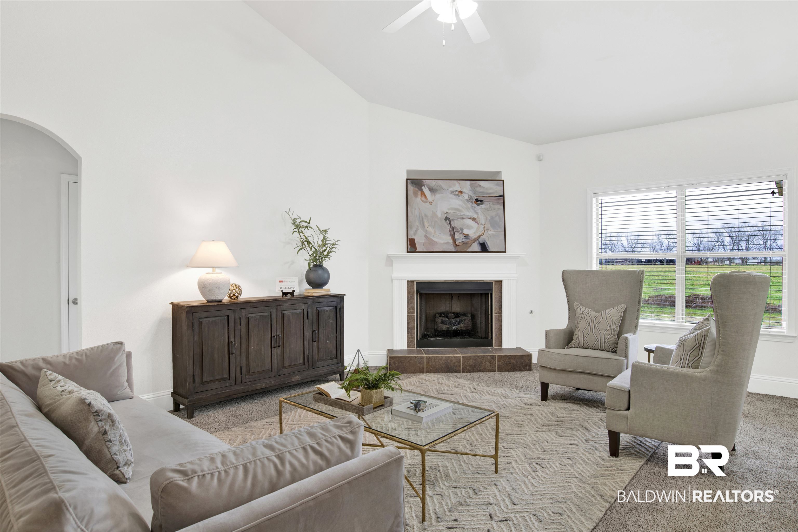 25350 Spindle Lane Daphne, AL 36526 - Photo 9 of 32 Carpeted living room featuring a tile fireplace, lofted ceiling, and ceiling fan