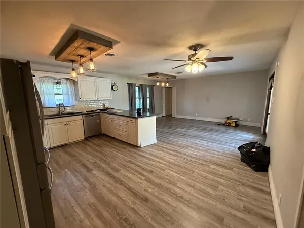 a kitchen with stainless steel appliances a stove a refrigerator and a sink