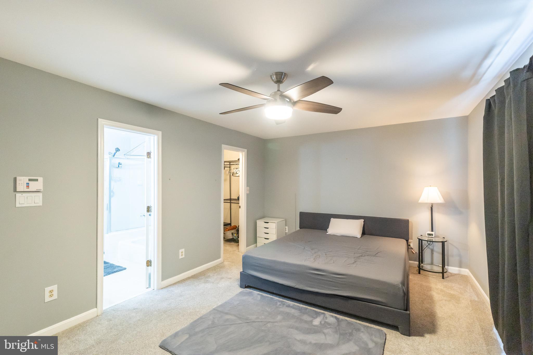6005 Honnicut Drive Centreville, VA 20121 - Photo 14 of 29 a bedroom with a large bed and a chandelier