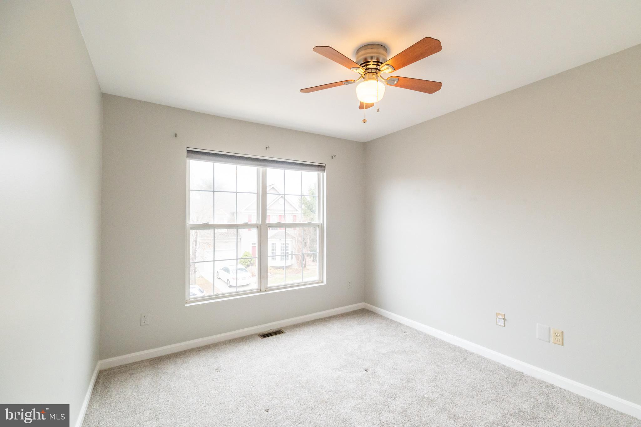 6005 Honnicut Drive Centreville, VA 20121 - Photo 20 of 29 an empty room with window and ceiling fan