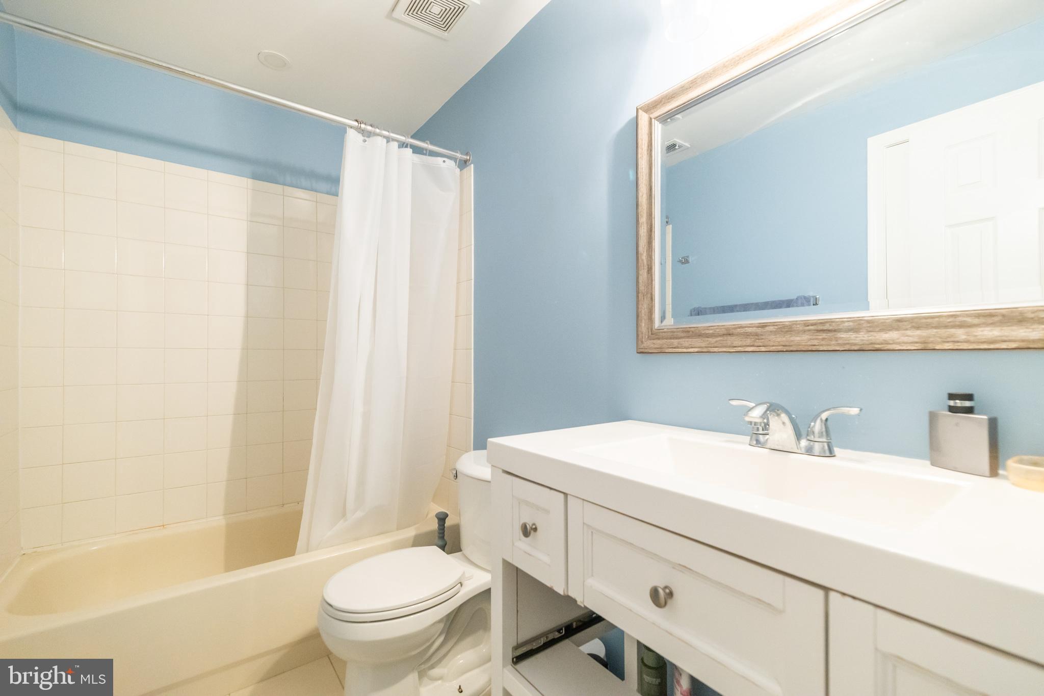 6005 Honnicut Drive Centreville, VA 20121 - Photo 24 of 29 a bathroom with a sink a toilet and a mirror