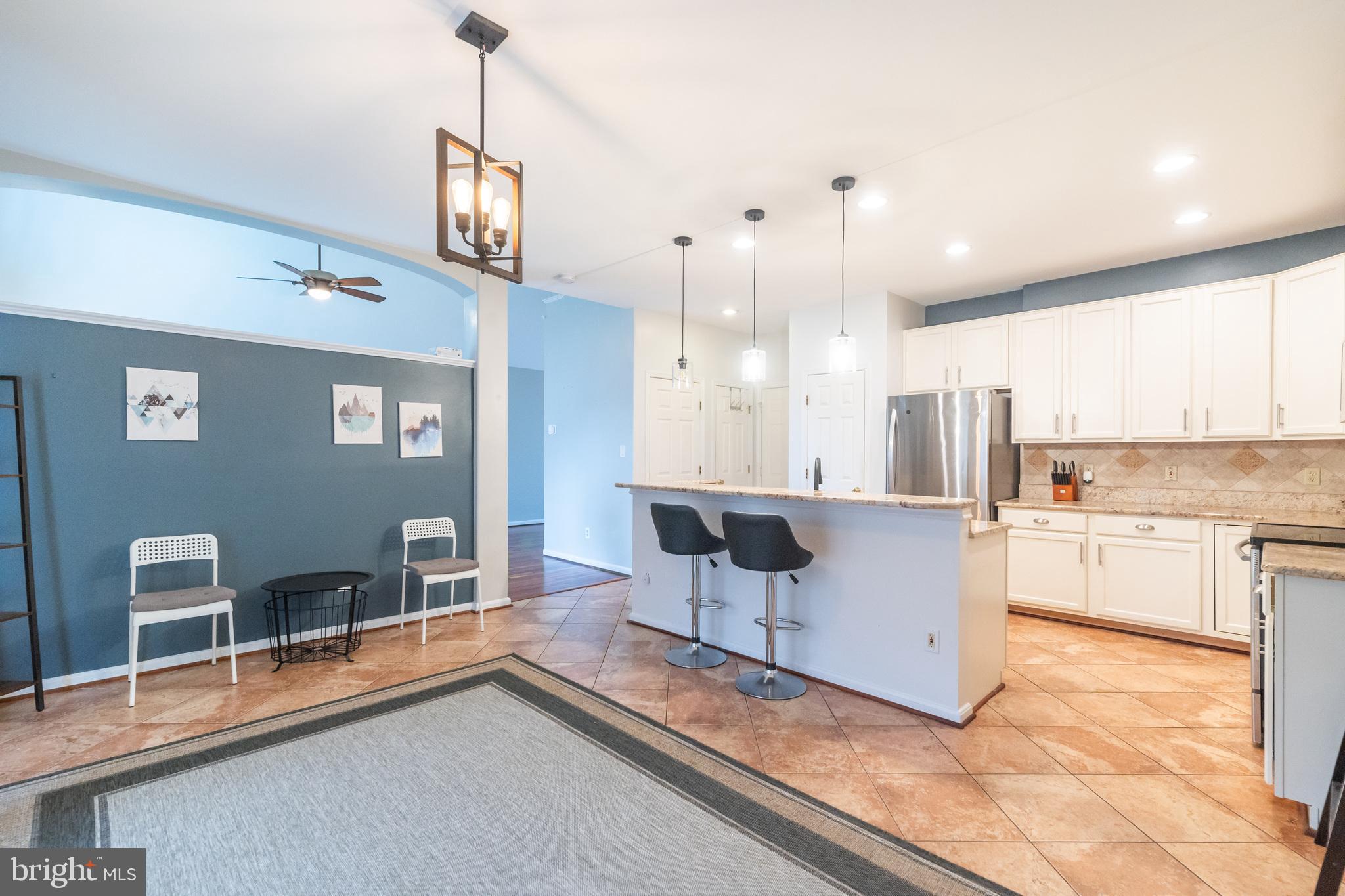 6005 Honnicut Drive Centreville, VA 20121 - Photo 5 of 29 a kitchen with stainless steel appliances granite countertop a stove a sink and a refrigerator