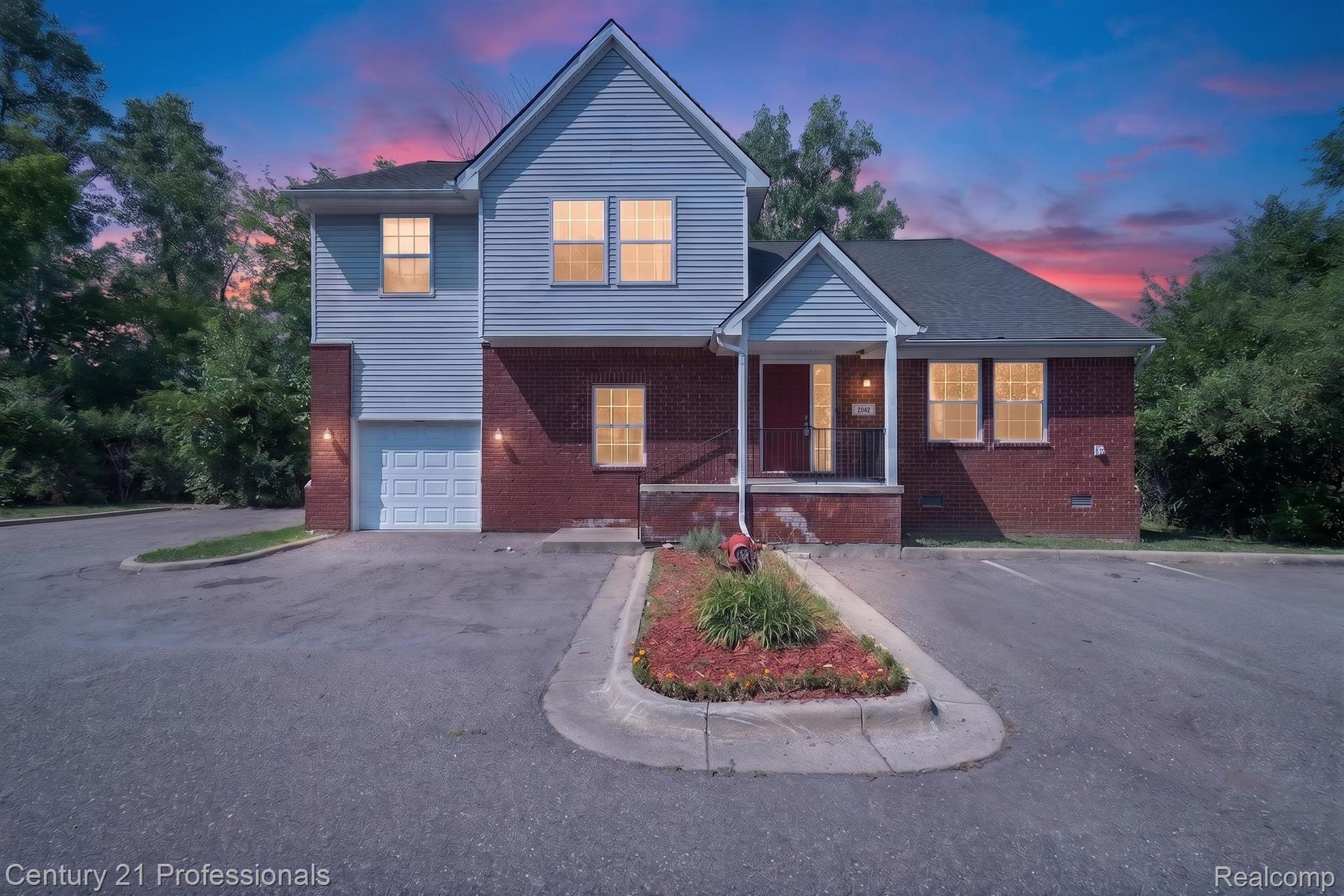 2042 Decker Road Walled Lake, MI 48390 - Photo 1 of 48 Multi-level property featuring a brick and siding exterior, an attached garage, a covered front entry, and multiple parking spaces
