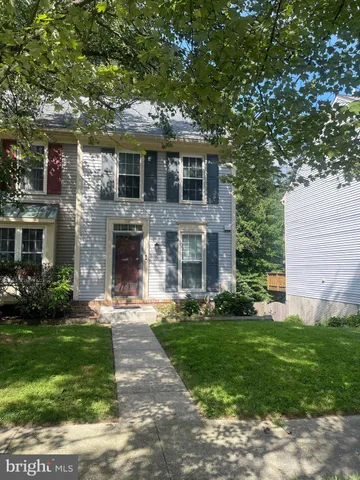 a front view of a house with a garden and yard