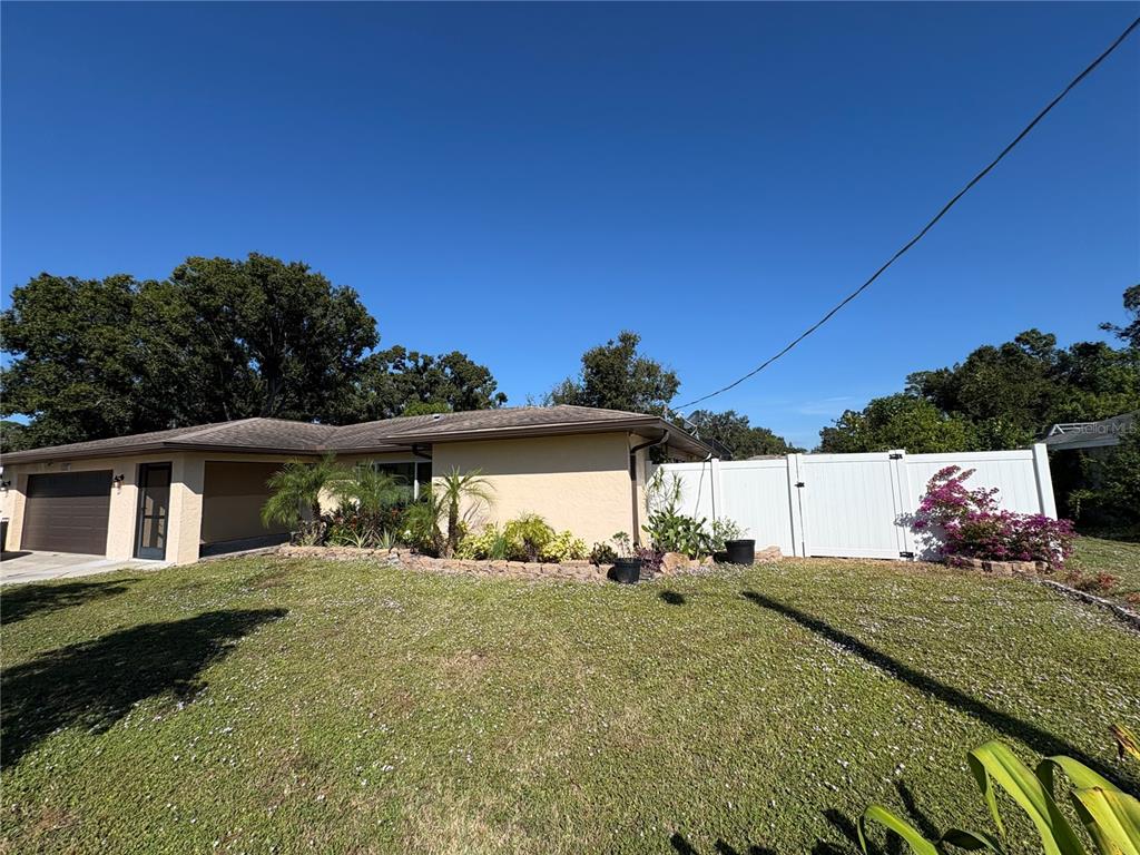 1117 Angela Maria Road Sarasota, FL 34243 - Photo 17 of 52 a front view of a house with a yard