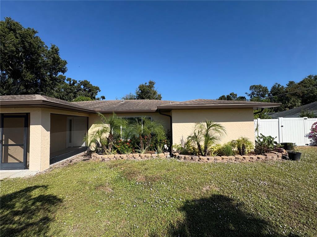 1117 Angela Maria Road Sarasota, FL 34243 - Photo 18 of 52 a front view of a house with a yard