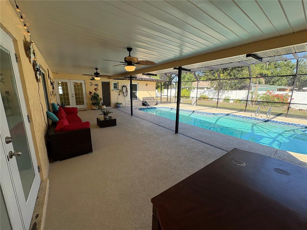 1117 Angela Maria Road Sarasota, FL 34243 - Photo 19 of 52 a living room with lots of furniture and a chandelier