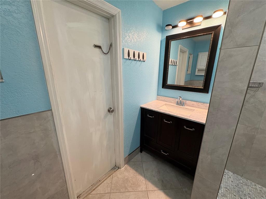 1117 Angela Maria Road Sarasota, FL 34243 - Photo 33 of 52 a bathroom with a vanity and a mirror