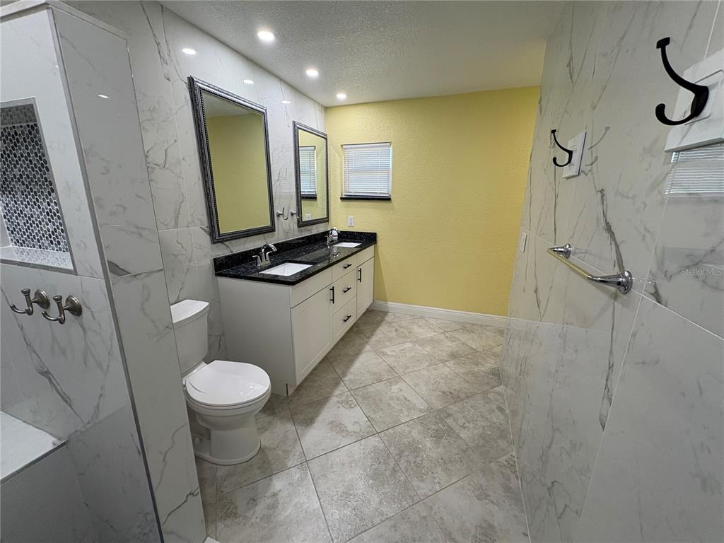 1117 Angela Maria Road Sarasota, FL 34243 - Photo 41 of 52 a bathroom with a sink toilet and shower