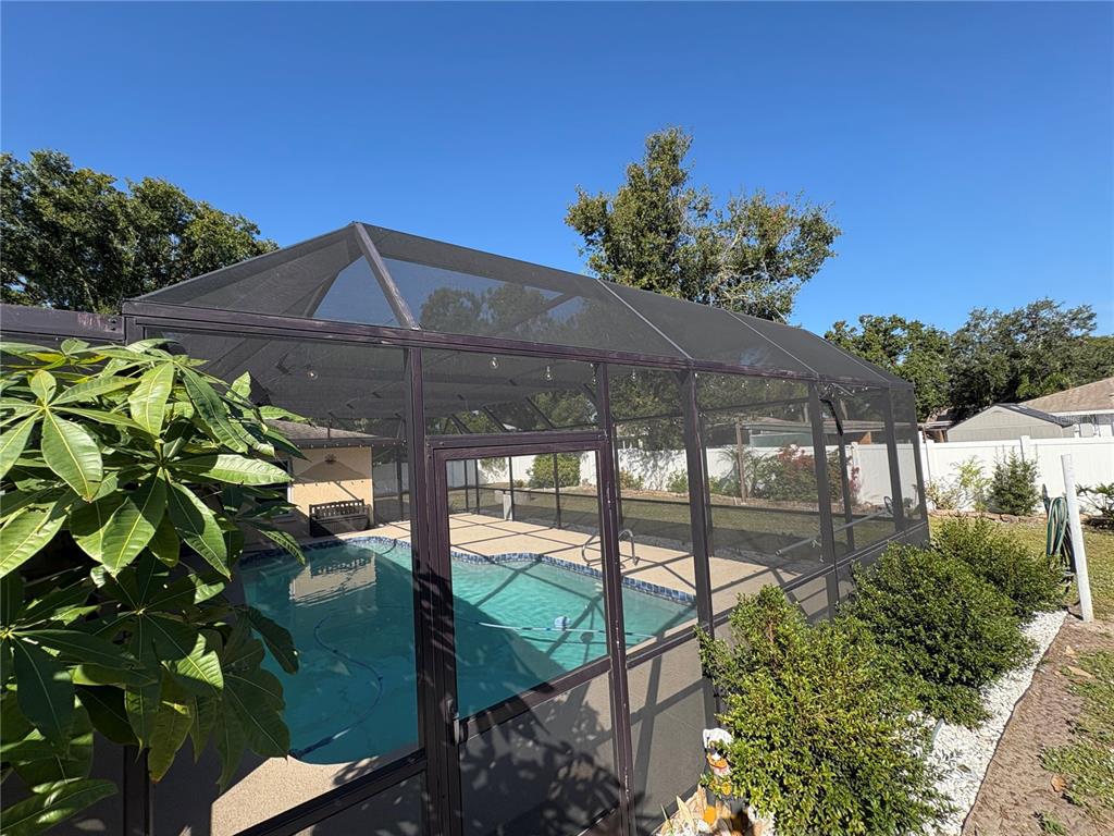 1117 Angela Maria Road Sarasota, FL 34243 - Photo 45 of 52 a backyard of a house with a garden