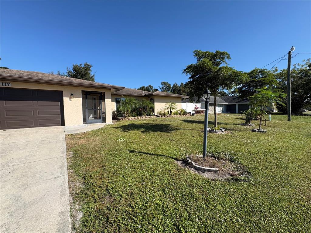 1117 Angela Maria Road Sarasota, FL 34243 - Photo 51 of 52 a backyard of a house with lots of green space