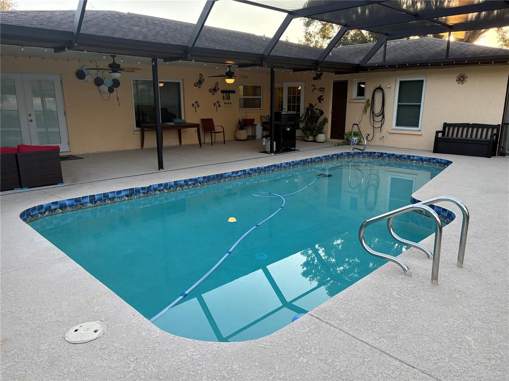 1117 Angela Maria Road Sarasota, FL 34243 - Photo 9 of 52 a view of a swimming pool with chairs