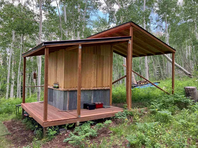 an aerial view of residential houses with outdoor space and trees