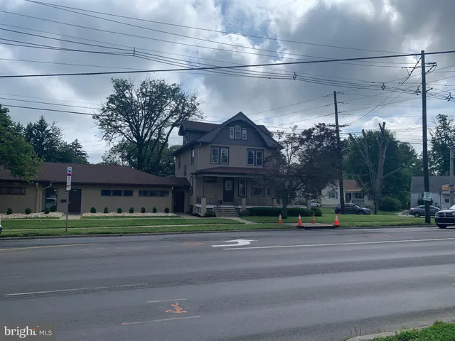 a city street lined with buildings and trees