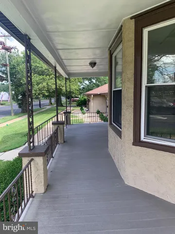 a view of a porch with furniture and garden