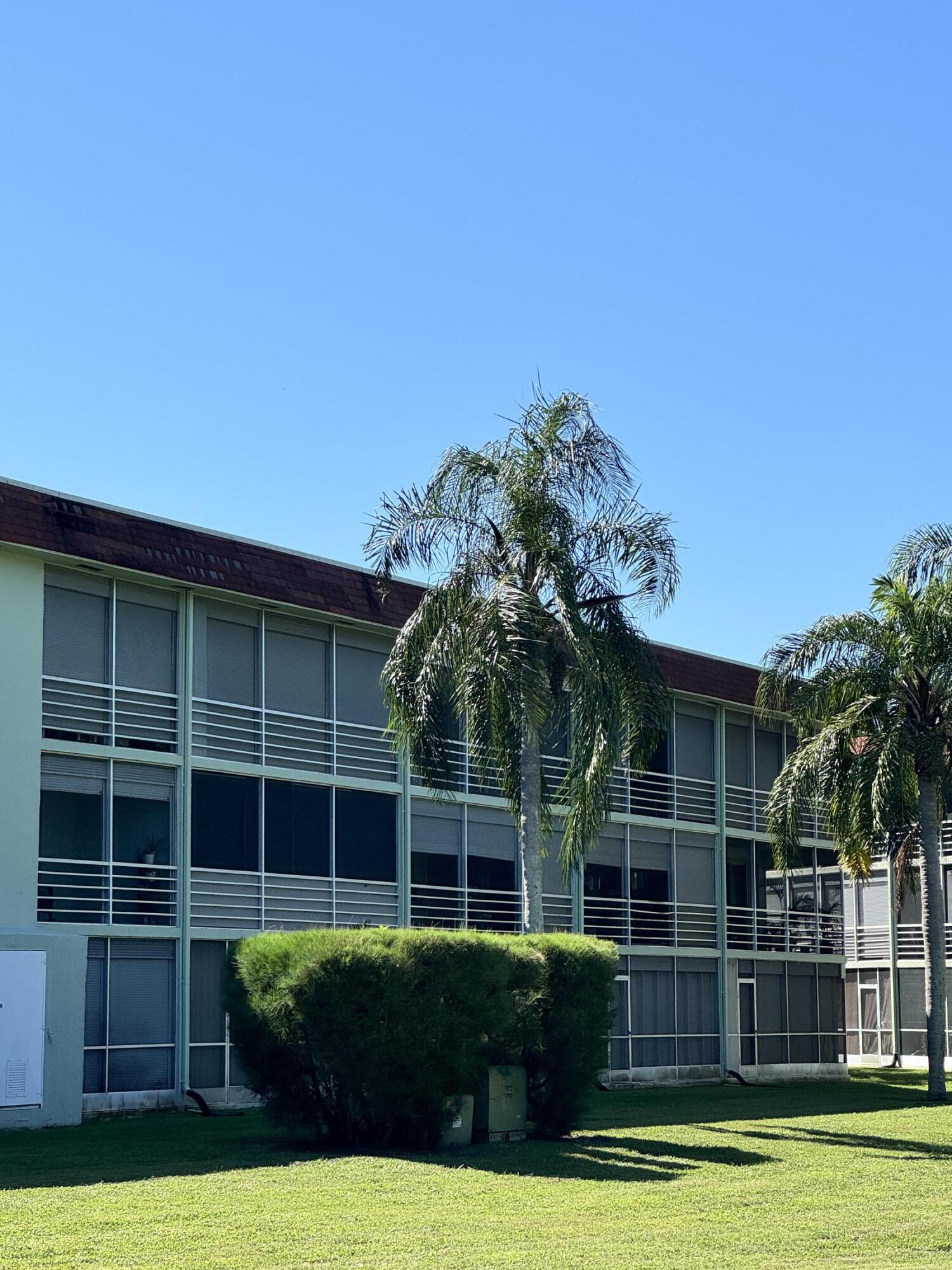 3000 Springdale Boulevard, Unit V303 Palm Springs, FL 33461 - Photo 5 of 22 a view of a house with a backyard