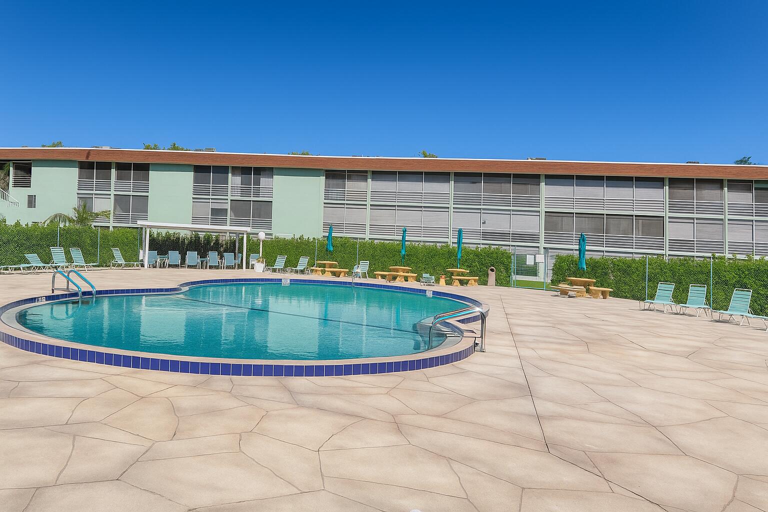 3000 Springdale Boulevard, Unit V303 Palm Springs, FL 33461 - Photo 7 of 22 a house view with a swimming pool and sitting space